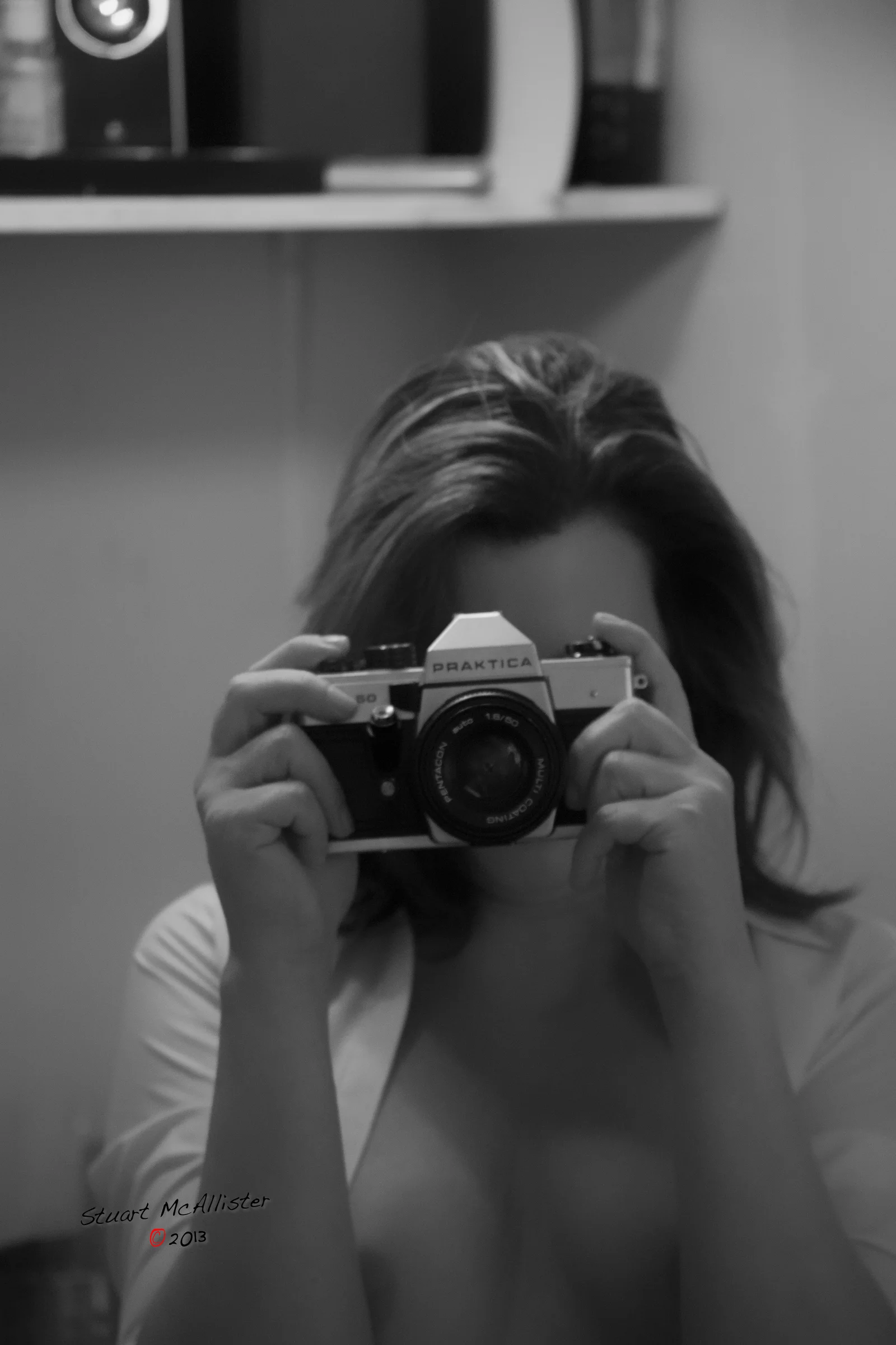 The photographer and the act of looking become part of the image.