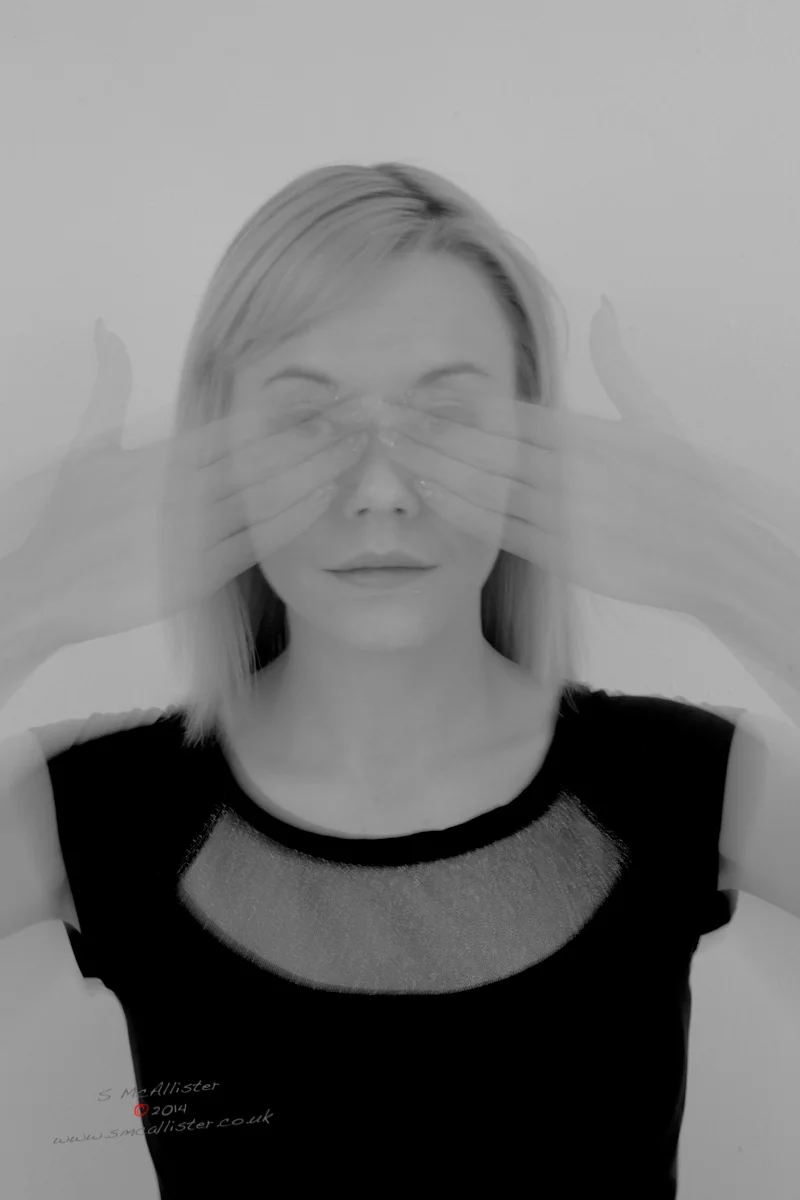 A portrait turns away from something just outside the frame.